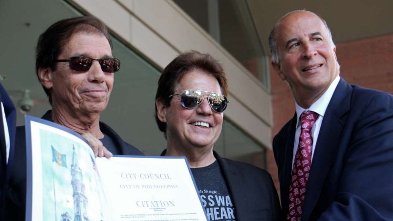 Members of the group Soul Survivor (from left) Charlie Ingui and Kenny Jeremiah, accept a citation from City Councilman Mark Squilla (right).