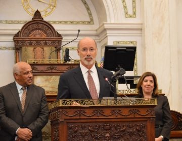 Tom Wolf at the podium in Philadelphia City Hall, Council chambers