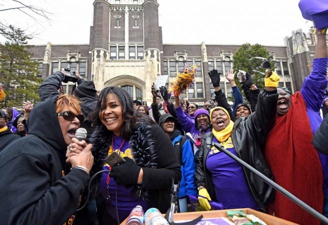 At a block party in November 2016 to celebrate Camden High, alumni greet others over a microphone.  Carmen Lozada, second from left, helped organize the event as an officer of the Camden High Alumni Association, (April Saul/for Newsworks)