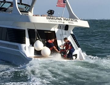U.S. Coast Guard crew members help dewater a vessel off Cape May on Wednesday. (Photo courtesy of the USCG)