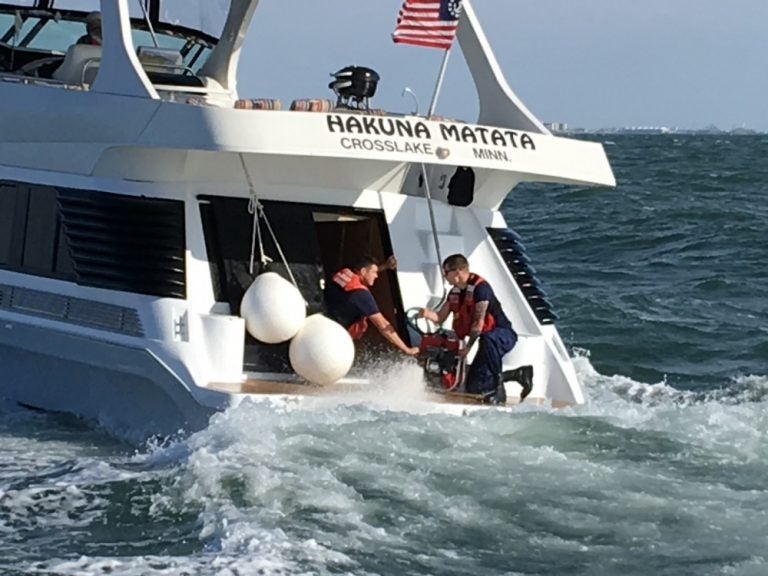 U.S. Coast Guard crew members help dewater a vessel off Cape May on Wednesday. (Photo courtesy of the USCG)