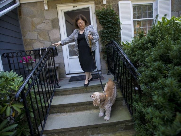 After two weeks of recovery from an addiction to opioids prescribed by her surgeon, Katie Herzog takes a walk with her dog, Pippen. (Jesse Costa/WBUR) 