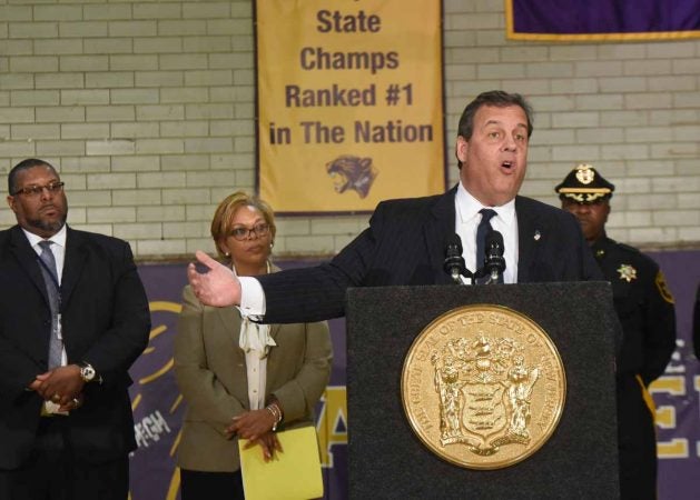 With Camden Mayor Dana Redd behind him, Governor Chris Christie celebrates the new plan for the school at an October 4, 2016 press conference at Camden High. (April Saul/for Newsworks)