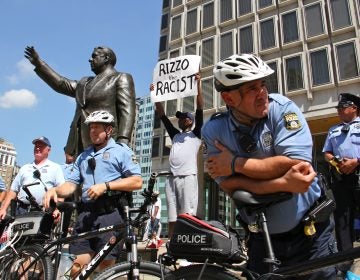 Philadelphia police protect the Frank Rizzo statue during a protest