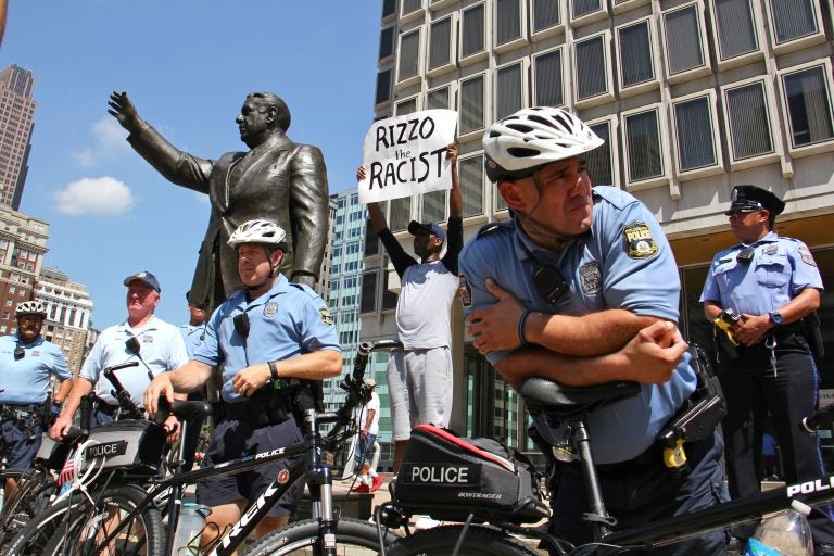 Philadelphia police protect the Frank Rizzo statue during a protest