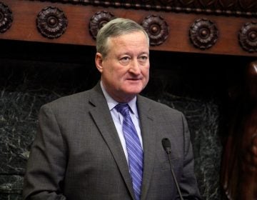 Philadelphia Mayor Jim Kenney stands behind a podium in the Mayor's Reception Room