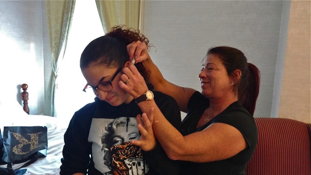 Redina Rodriguez tends to her daughter, Jordyn's piercing during a reunion in Williamsport, Pennsylvania.