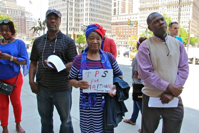 Marie Belfort (center) and other Haitian Philadelphians gather outside City Hall to celebrate Haitian Flag Day
