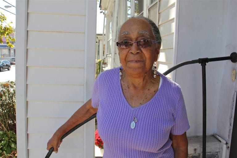 Ruth Willis stands outside her home on 62nd Street, where she has lived since 1959. (Emma Lee/WHYY)