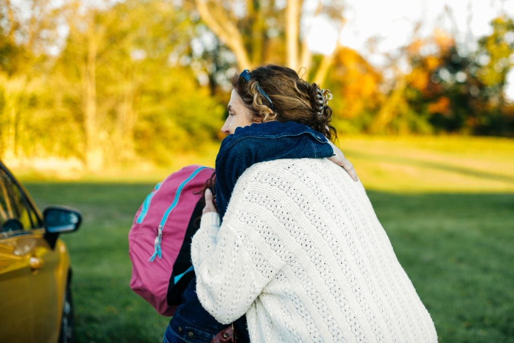 A staff member of the Roxbury Treatment Center in Shippensburg, Pennsylvania hugs Redina and wishes her well as she gets ready to leave.