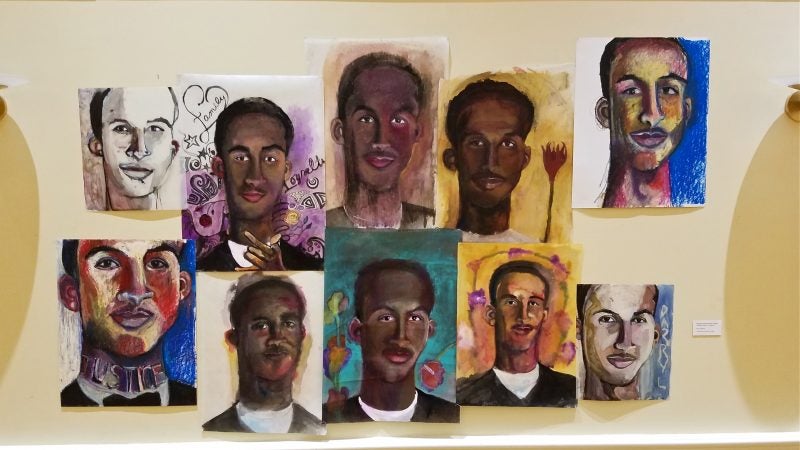 Portraits of the victims of gun violence hang on the walls at the chestnut hill presbyterian church