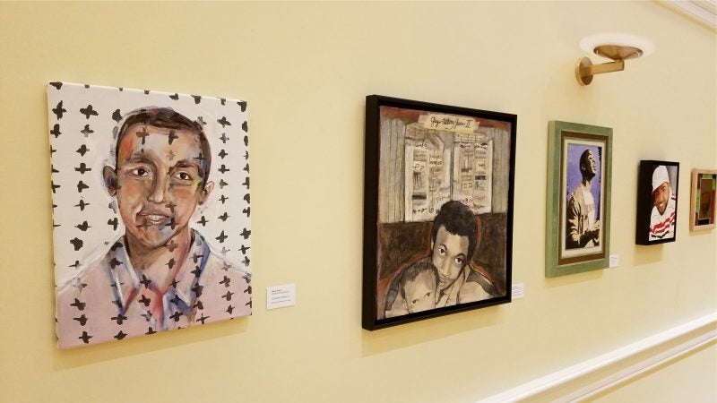 Portraits of the victims of gun violence hang on the walls at the chestnut hill presbyterian church