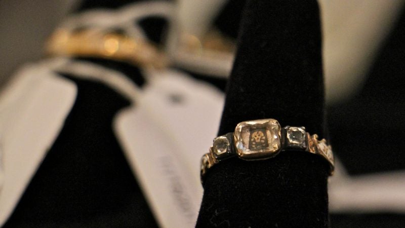 A gold and enamel mourning ring commemorates the death of a 9-month-old child in 1765. A tiny skull is set beneath a faceted crystal.