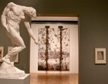 A Rodin sculpture of a nude man is juxtaposed with an abstract work by Anselm Kiefer