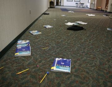 Photo, books and supplies litter the floor in this Indiana classroom during an intruder drill in 2016. Delaware requires schools to conduct two lockdown/active shooter drills a year. (Associated Press)