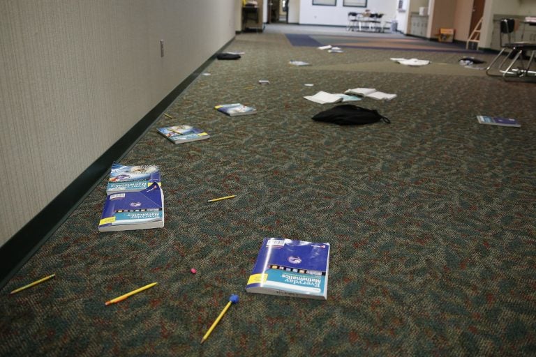 Photo, books and supplies litter the floor in this Indiana classroom during an intruder drill in 2016. Delaware requires schools to conduct two lockdown/active shooter drills a year. (Associated Press)