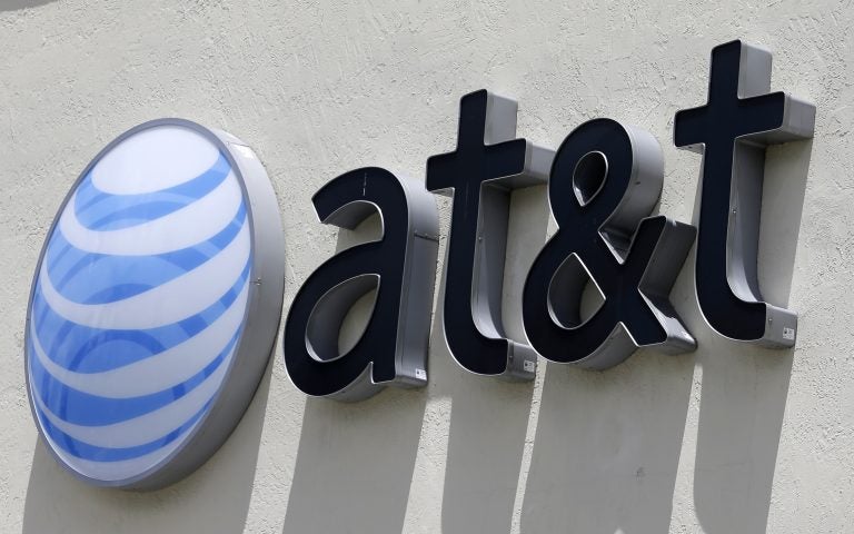 FILE - This Thursday, July 27, 2017, file photo shows an AT&T logo at a store in Hialeah, Fla.