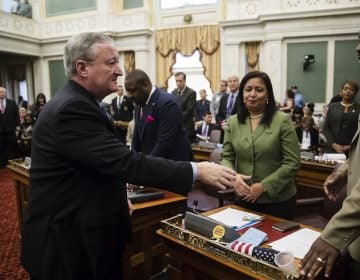 Philadelphia Mayor Jim Kenney, left, shakes hands with members of City Council after speaking at City Hall in Philadelphia. Kenney on Thursday called for the panel that governs the city's schools to be dissolved and replaced by mayor-appointed board.