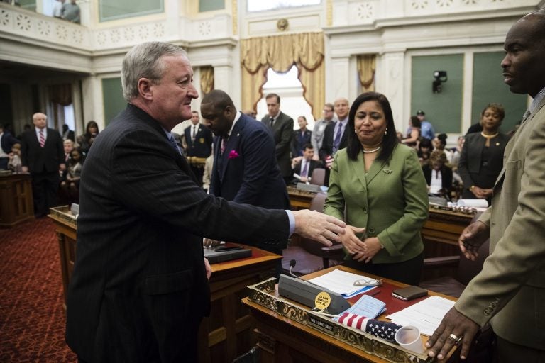 Philadelphia Mayor Jim Kenney, left, shakes hands with members of City Council after speaking at City Hall in Philadelphia. Kenney on Thursday called for the panel that governs the city's schools to be dissolved and replaced by mayor-appointed board.