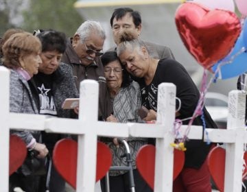 Family and friends gather around a makeshift memorial for the victims of the First Baptist Church shooting at Sutherland Springs Baptist Church, Friday, Nov. 10, 2017, in Sutherland Springs, Texas. A man opened fire inside the church in the small South Texas community on Sunday, killing more than two dozen. (Eric Gay/AP Photo)