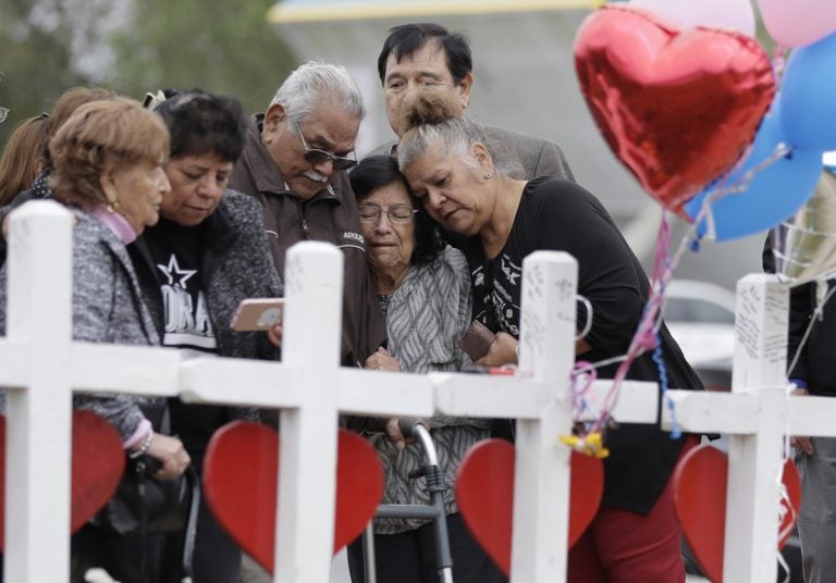 Family and friends gather around a makeshift memorial for the victims of the First Baptist Church shooting at Sutherland Springs Baptist Church, Friday, Nov. 10, 2017, in Sutherland Springs, Texas. A man opened fire inside the church in the small South Texas community on Sunday, killing more than two dozen. (Eric Gay/AP Photo)