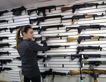 Gun shop owner Tiffany Teasdale-Causer returns a Ruger AR-15 semi-automatic rifle, the same model, though in gray rather than black, used by the shooter in a Texas church massacre two days earlier, to it's place on a wall with dozens of other semi-automatic rifles, Tuesday, Nov. 7, 2017, in Lynnwood, Wash. Gun-rights supporters have seized on the Texas church massacre as proof of the well-worn saying that the best answer to a bad guy with a gun is a good guy with a gun. Gun-control advocates, meanwhile, say the tragedy shows once more that it is too easy to get a weapon in the U.S. (Elaine Thompson/AP Photo)