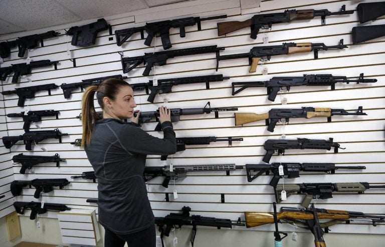 Gun shop owner Tiffany Teasdale-Causer returns a Ruger AR-15 semi-automatic rifle, the same model, though in gray rather than black, used by the shooter in a Texas church massacre two days earlier, to it's place on a wall with dozens of other semi-automatic rifles, Tuesday, Nov. 7, 2017, in Lynnwood, Wash. Gun-rights supporters have seized on the Texas church massacre as proof of the well-worn saying that the best answer to a bad guy with a gun is a good guy with a gun. Gun-control advocates, meanwhile, say the tragedy shows once more that it is too easy to get a weapon in the U.S. (Elaine Thompson/AP Photo)