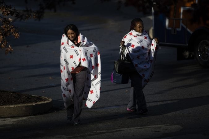 People walk from a bus in the aftermath of a fire at the the Barclay Friends Senior Living Community in West Chester, Pa., Friday, Nov. 17, 2017.  At least 20 people have been injured in a massive fire at the senior living community about 35 miles west of Philadelphia. (Matt Rourke/AP Photo)
