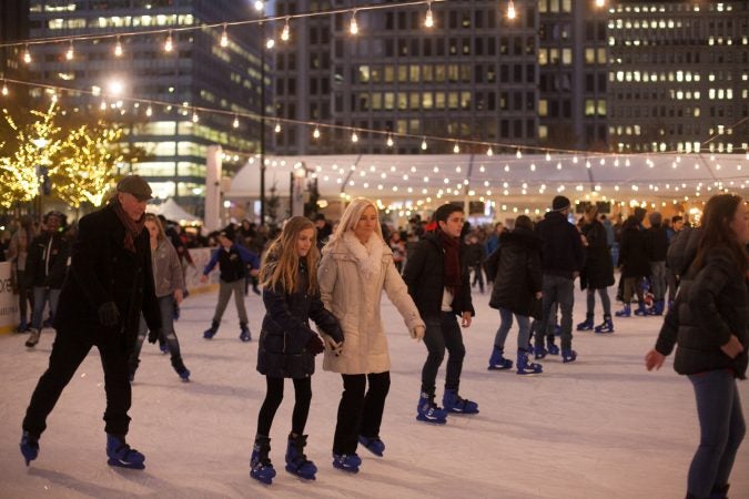 Ice skaters skate in the rink