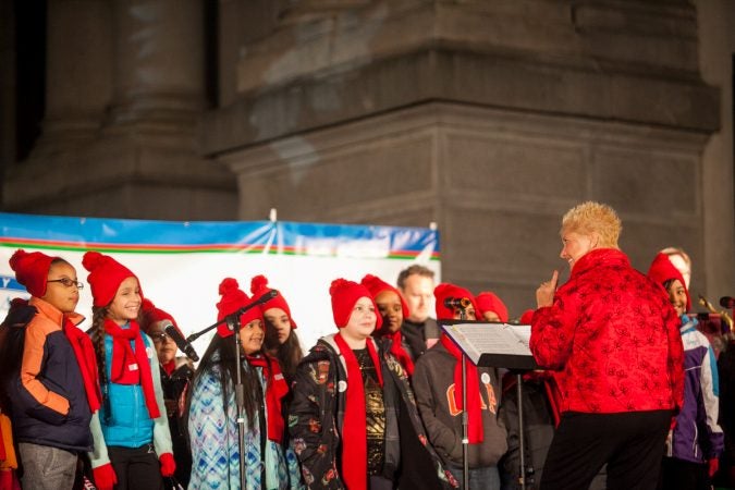 Students from Isaac A. Sheppard Elementary sing Christmas carols before the lighting of the City Hall Christmas Tree Friday evening. (Brad Larrison for WHYY)