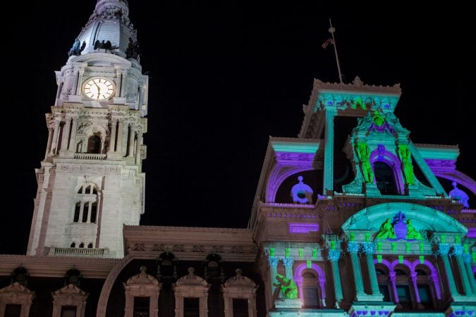 The facade of City Hall is lit by spotlights for the Christmas season. (Brad Larrison for WHYY)