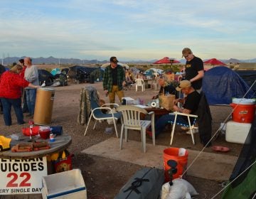 Volunteers and residents mingle in Camp Alpha at dinnertime.