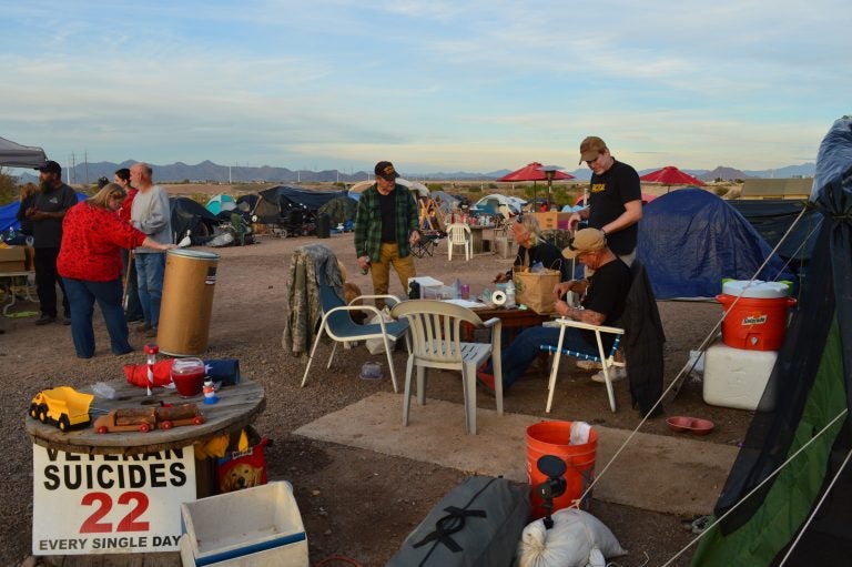 Volunteers and residents mingle in Camp Alpha at dinnertime.