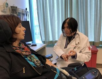 Dr. Terry Heiman-Patterson meets with Pat Vitkow, a patient with ALS. (Joel Wolfram for WHYY)