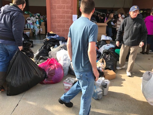 Volunteers at Good Will Fire Company No. 2 help sort through donations for residents displaced by the five-alarm fire at Barclay Friends Senior Living Community in West Chester, Pa. (Shai Ben-Yaacov, WHYY)