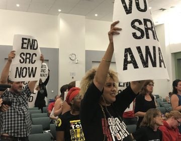 At the June 15 School Reform Commission meeting, demonstrators carried signs calling for the SRC to vote itself out of existence and return the school district to city control. (David Hornbeck/The Notebook)