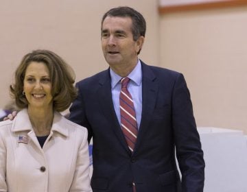 Democratic gubernatorial candidate Lt. Gov. Ralph Northam, right, and his wife, Pam, carry their ballots to the tally machine in Norfolk, Va.