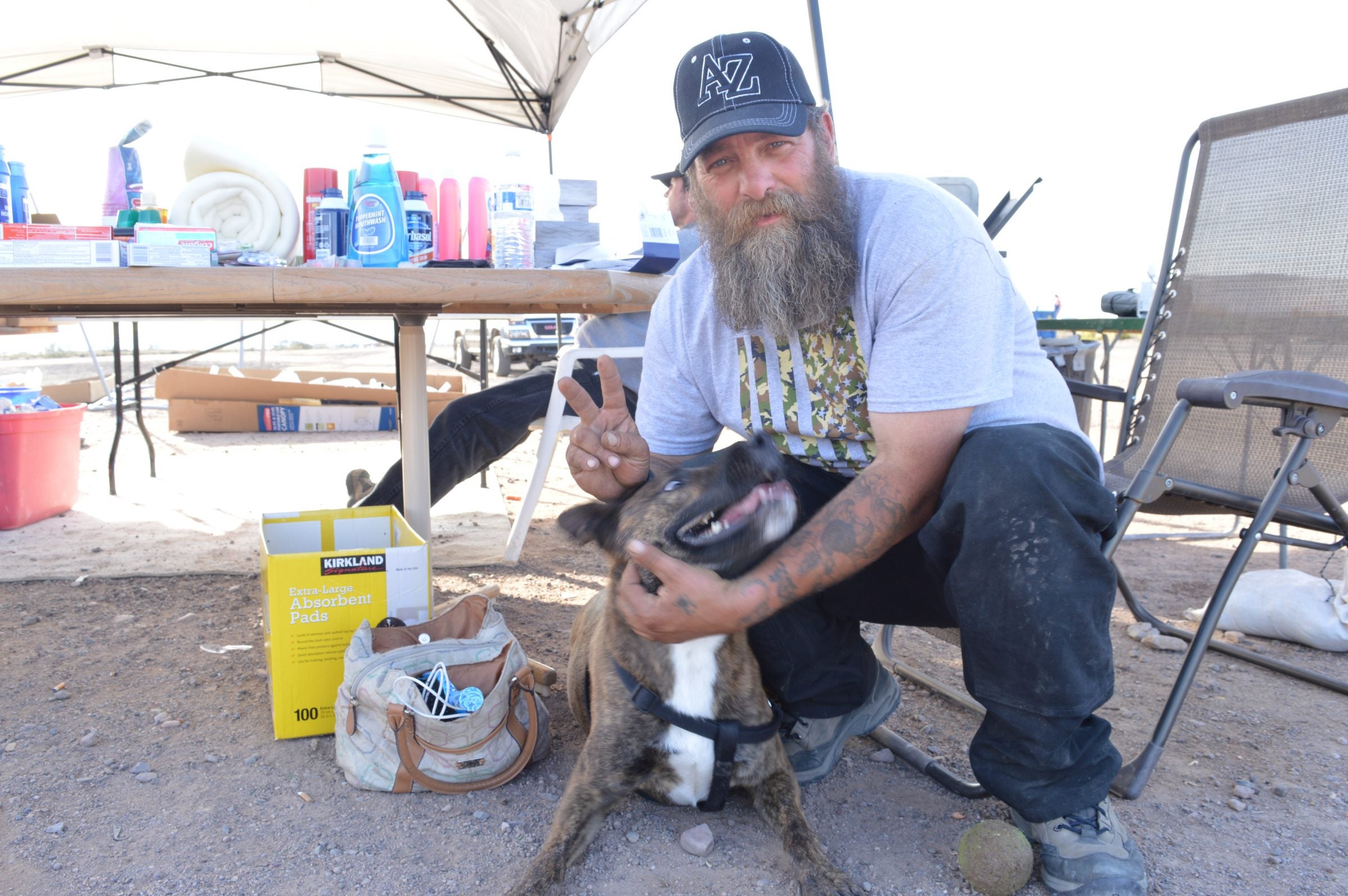 Christopher White, a member of Camp Alpha's security team, with one of the resident dogs.