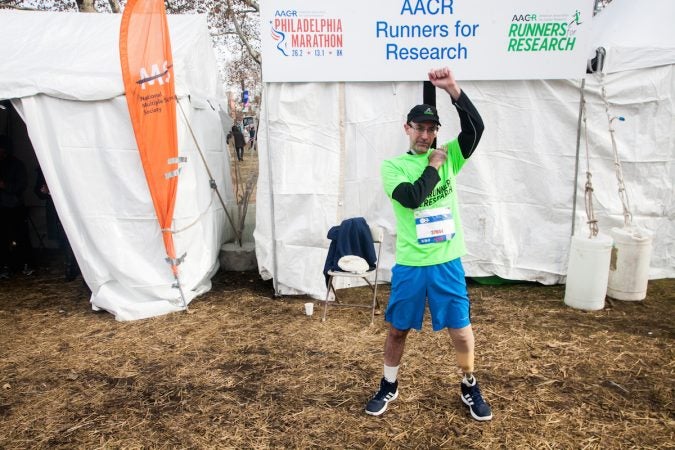 Evan Freiberg stretches before the Rothman Institute 8k Saturday. The 43-year-old is diagnosed with leiomyosarcoma, a form of cancer, and competed after losing the bottom portion of his left leg to the disease. (Brad Larrison for WHYY)