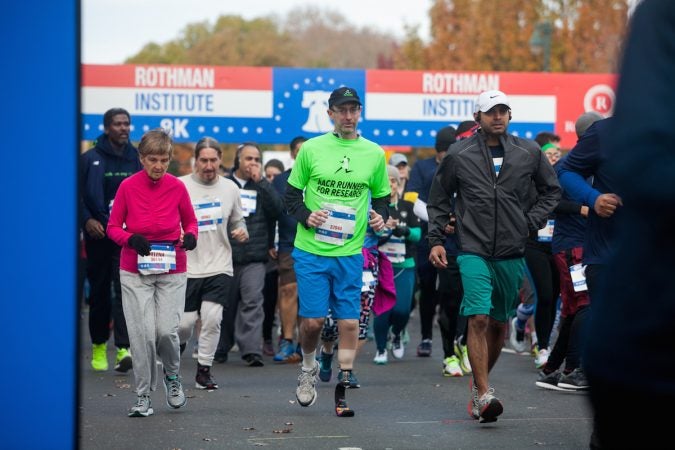 Evan Freiberg runs with the pack at the start of the Rothman Institute 8k Saturday. The 43-year-old is diagnosed with leiomyosarcoma, a form of cancer, and competed after losing the bottom portion of his left leg to the disease. (Brad Larrison for WHYY)