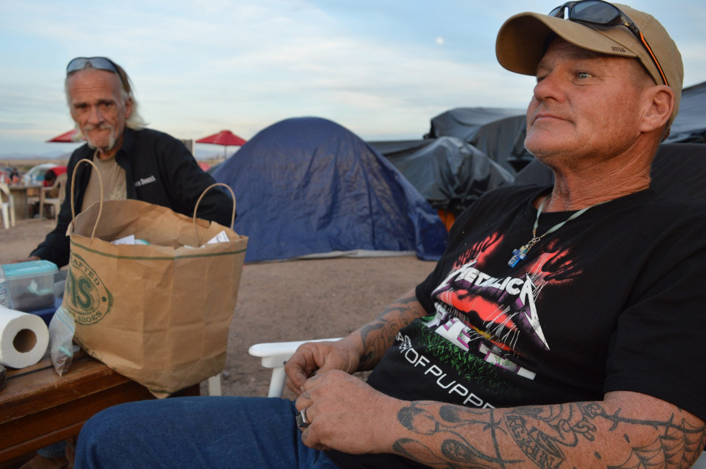 Camp commander Tim Johnson relaxes outside his tent near the end of the day.