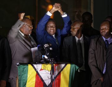 
Emmerson Mnangagwa, center, greets supporters gathered outside the ZANU-PF party headquarters in downtown Harare, Zimbabwe on Wednesday. (Ben Curtis/AP) 