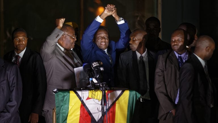 
Emmerson Mnangagwa, center, greets supporters gathered outside the ZANU-PF party headquarters in downtown Harare, Zimbabwe on Wednesday. (Ben Curtis/AP) 