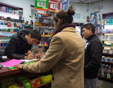 Gerardo Aguillon Castro (right) and Alana Adams, left, canvass businesses and homes in South Philadelphia as part of a 