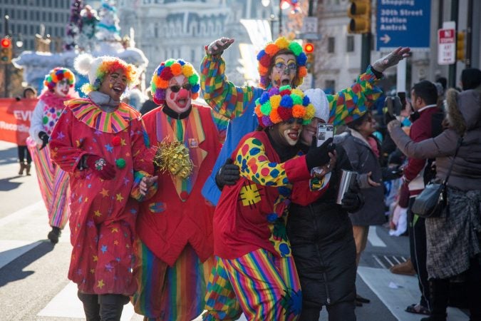 Clowns marching in the parade take a selfie with a spectator at the 98th annual Philadelphia Thanksgiving Day Parade, November 23, 2017. (Emily Cohen for WHYY)