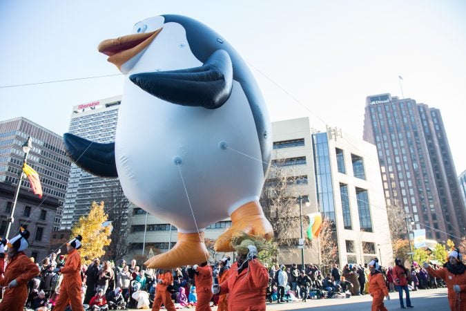 A penguins of Madagascar penguin floats down the parade route during the 98th annual Philadelphia Thanksgiving Day Parade, November 23, 2017. (Emily Cohen for WHYY)