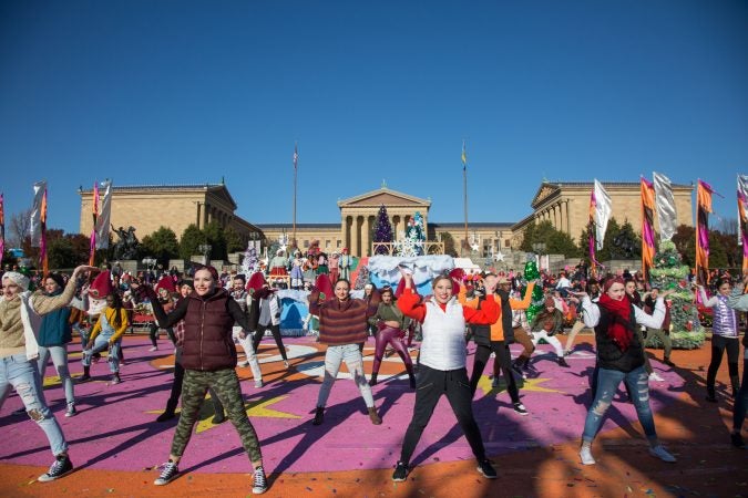 Dancers perform while musican, Evin, sings during the 6abc broadcast of the 98th annual Philadelphia Thanksgiving Day Parade, November 23, 2017. (Emily Cohen for WHYY)