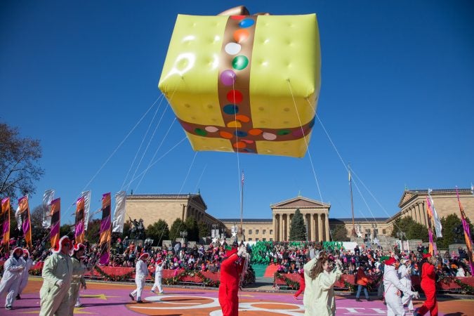 A present balloon floats over the Philadelphia Museum of Art during the 98th annual Philadelphia Thanksgiving Day Parade, November 23, 2017. (Emily Cohen for WHYY)