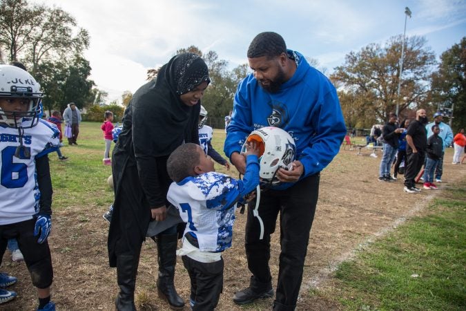 Rickey Duncan and his wife, Tahira, help Zaid, 4, into his helmet.