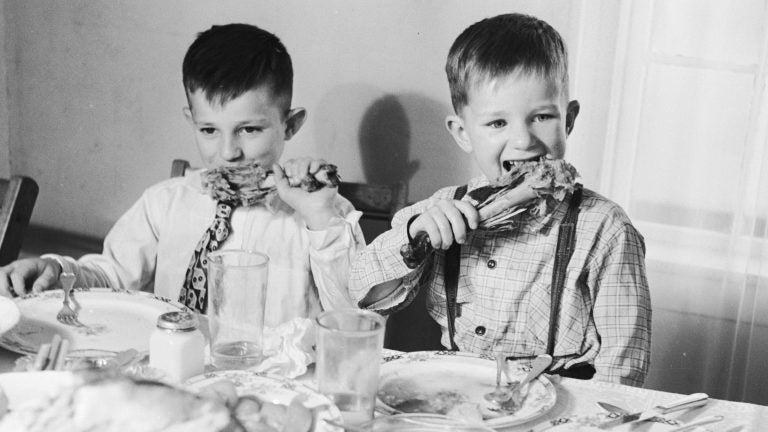 

Grabbing turkey legs to gnaw on might be taboo at some tables and encouraged at others. But whatever your Thanksgiving traditions, they're all yours. (Evans/Getty Images) 